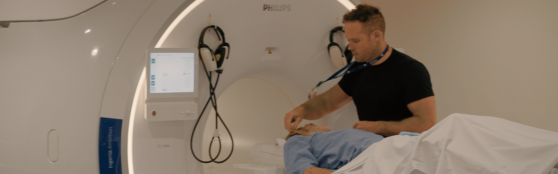 Dan Courtland with MRI patient, prepping for the test